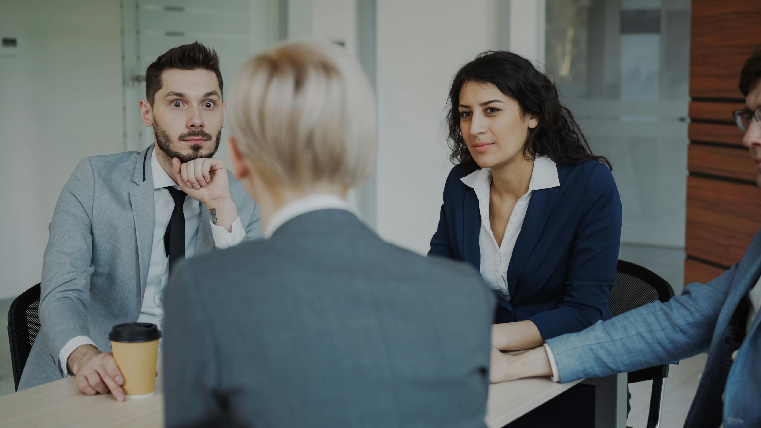 Business professionals in a focused meeting in a contemporary office space.